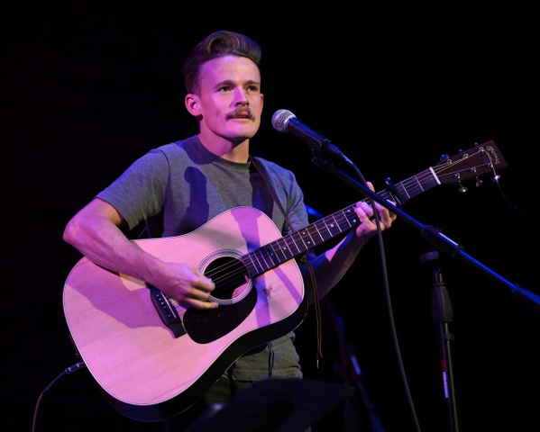 Alabama singer onstage performing a song at an event | Altus Entertainment